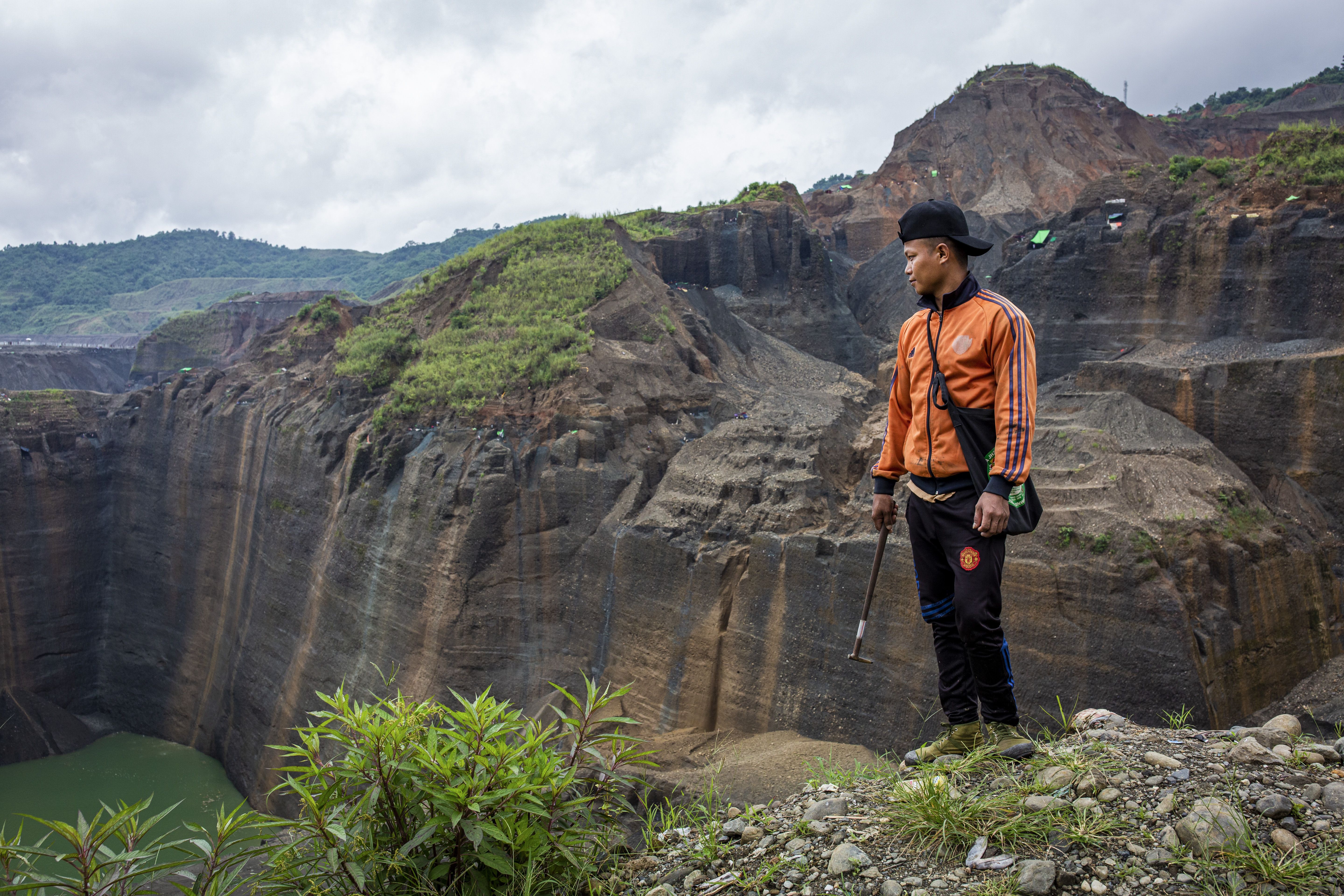 Gum Jat, 31, looks over a jade mining site in Hpakant, Kachin State, where he has worked as a freelance miner for eight years. Image by Hkun Lat/Frontier. Myanmar, 2020.