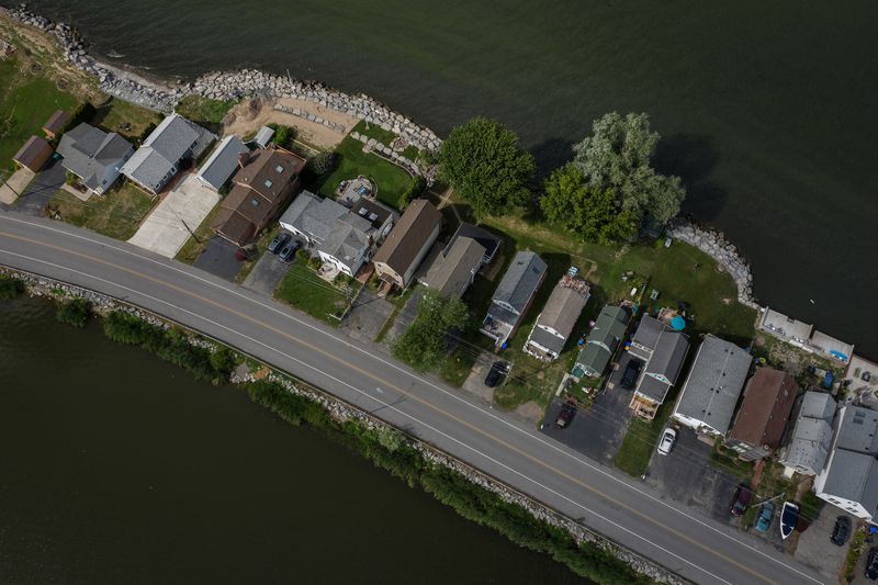 The houses along Edgemere Drive on Lake Ontario and Cranberry Pond are shown in Greece, New York. Homeowners here have paid to put large boulders in front of their properties to prevent erosion. Image by Zbigniew Bzdak/Chicago Tribune. United States, 2020.