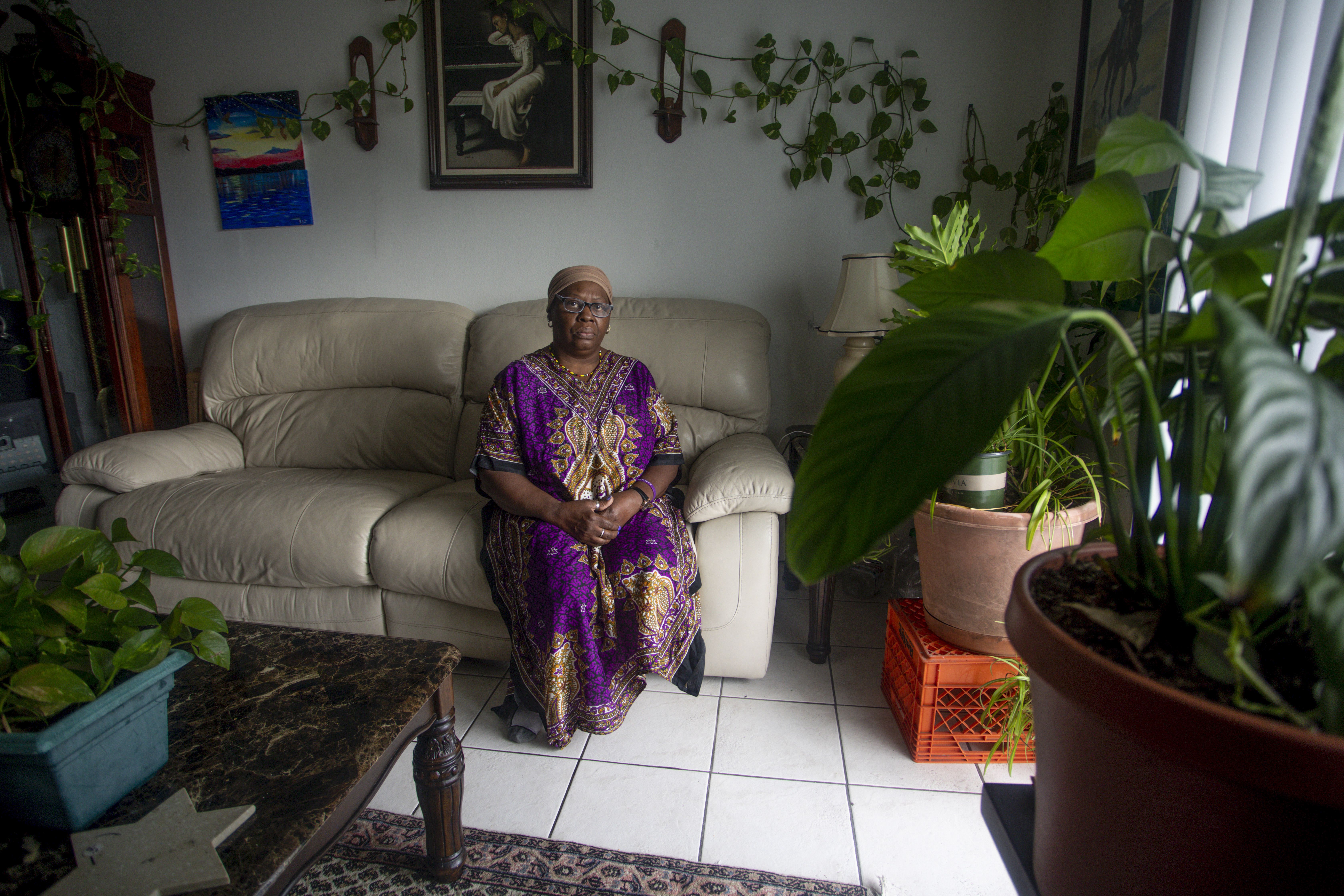 Yochebed Israel, 59, poses for a portrait inside her Tampa, Florida, apartment on Monday, Aug. 17, 2020. Israel, a nursing assistant, found an eviction notice on her door in May after being unable to pay rent since she contracted COVID-19 from her daughter in April, and could not return to work. “There’s a lot of despair in this situation,” Israel said. “Not only are you sick from COVID-19, you miss work, you miss your job, you miss getting paid, you miss a lot of things that dominoes into this situation.” Image by Ivy Ceballo. United States, 2020.