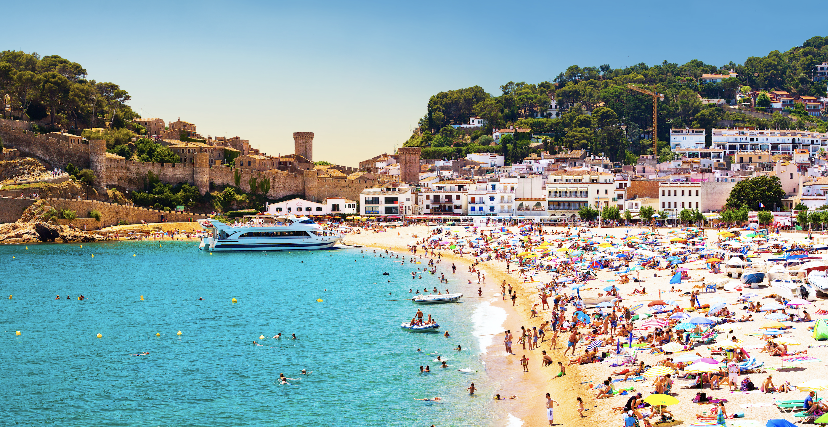 Coast with tanning and bathing people (Panorama of Costa Brava, Tossa de Mar city, Spain). Image by Denis Mironov/Shutterstock. Spain, undated. 