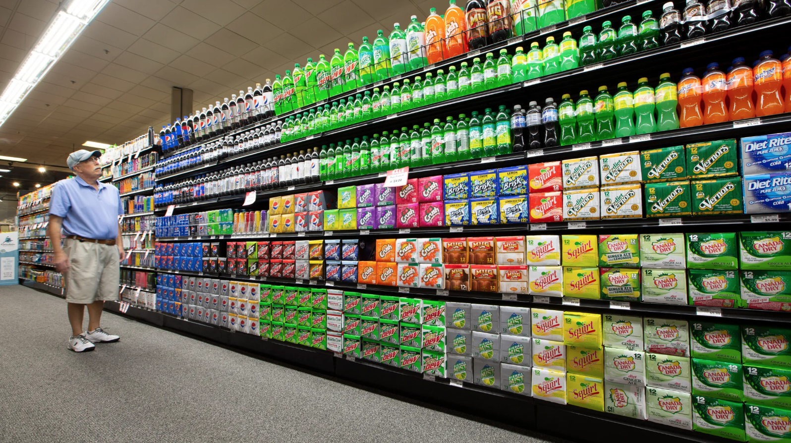 Steve Close of Fox Point shops in an aisle of sodas, energy drinks, drink mixers and more at Sendik's Food Market in Mequon. Image courtesy of Colin Boyle. United States, 2019.