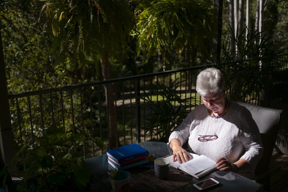 Deb Ware logs an entry in her diary at her home in Fountaindale, Central Coast, Australia, Friday, July 19, 2019. Deb has chronicled the swiftness of her son's downfall in her diary, her fury and fear catalogued alongside all the drugs, the hospitalizations and the broken promises. Image courtesy of David Goldman. Australia, 2019.