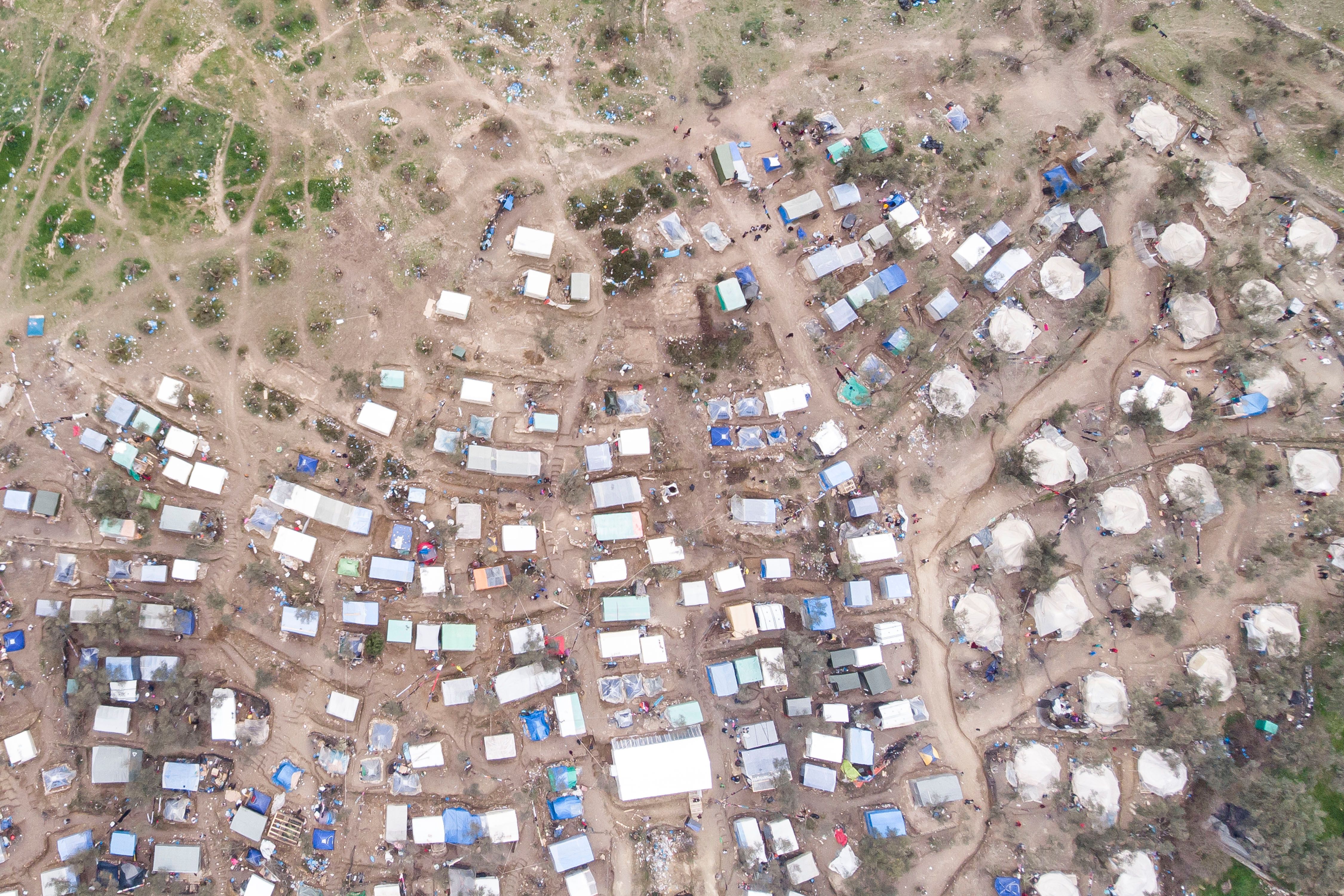 Aerial view of Moria Refugee camp and makeshift settlement around it. Image by Nicolas Economou / Shutterstock. Greece, 2020.