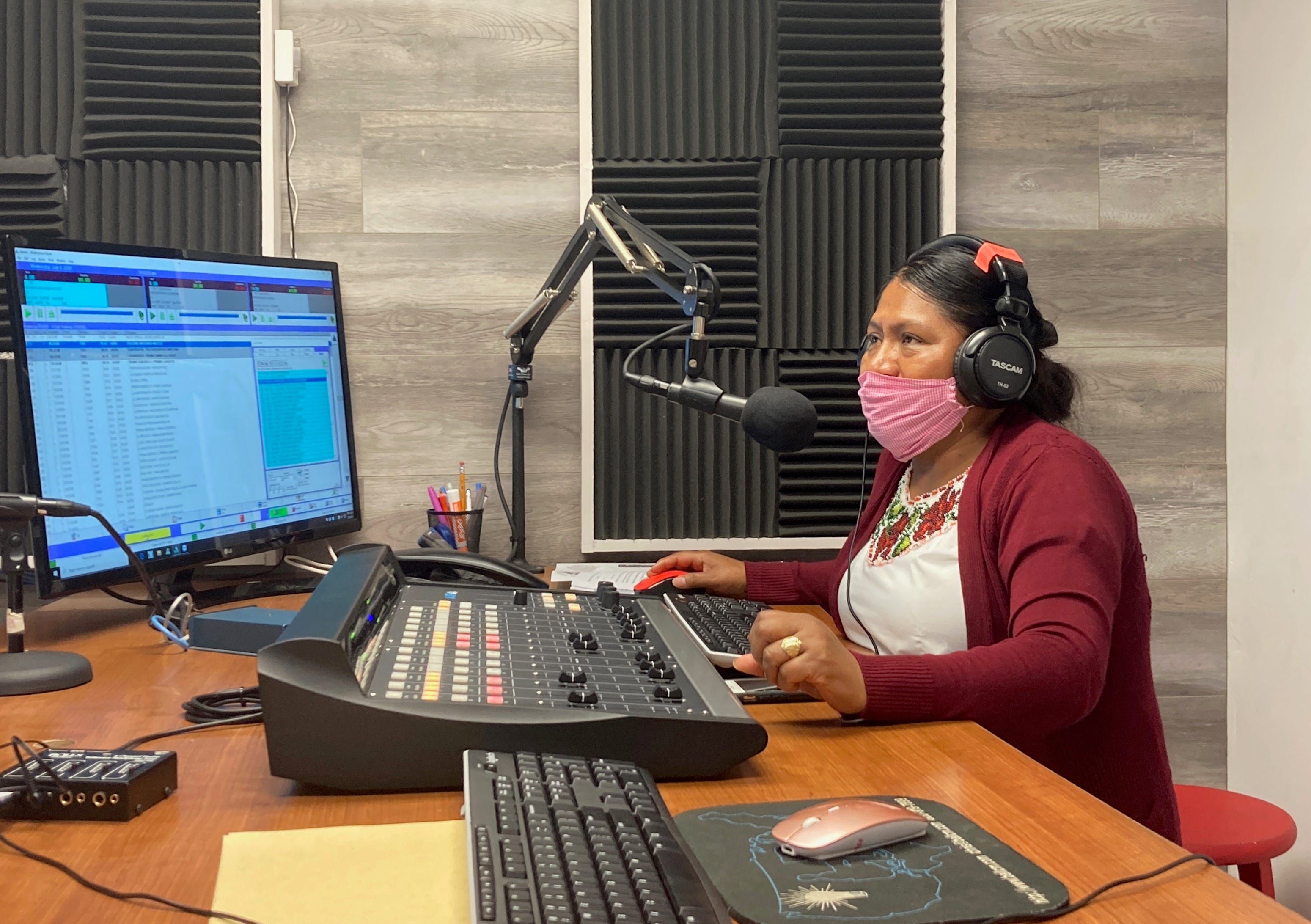 Lidia López prepares to go on-air from Radio Indígena's programming booth in Oxnard in July. Image by Julia Knoerr. United States, 2020.