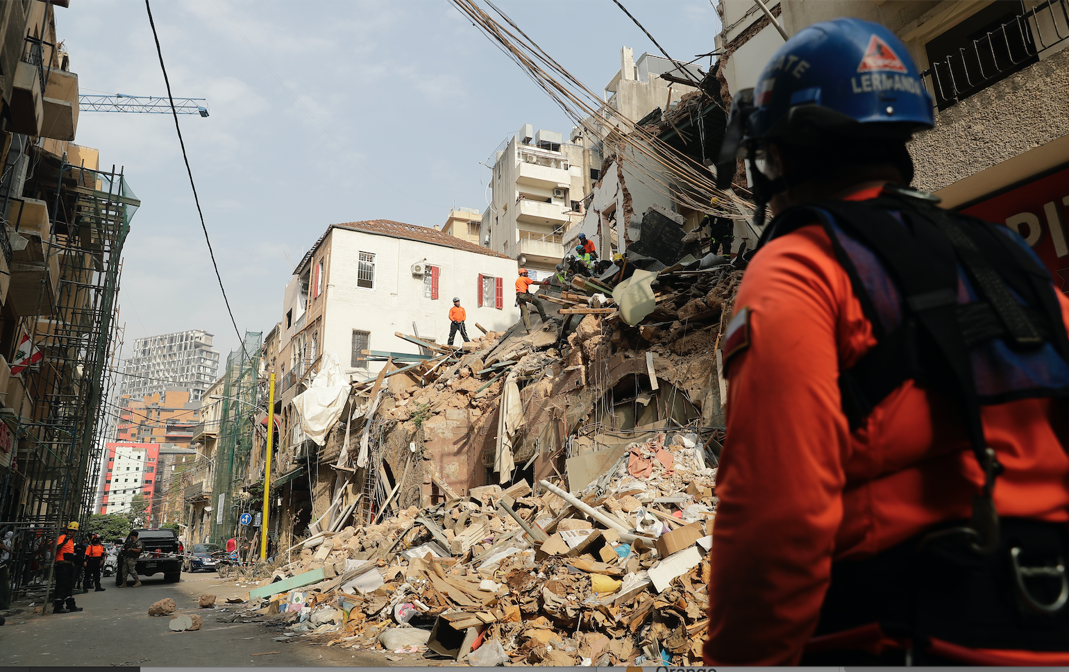 Rescue workers dig through the rubble of a badly damaged building in Lebanon's capital, Beirut, in search of possible survivors from a mega-blast at the adjacent port one month ago, after scanners detected a pulse, on September 3, 2020. A sniffer dog used by Chilean rescuers responded to a scent from the site of a collapsed building in the Gemmayzeh area, the city's governor told reporters at the scene. Image by Joseph Eid/AFP. Lebanon, 2020.