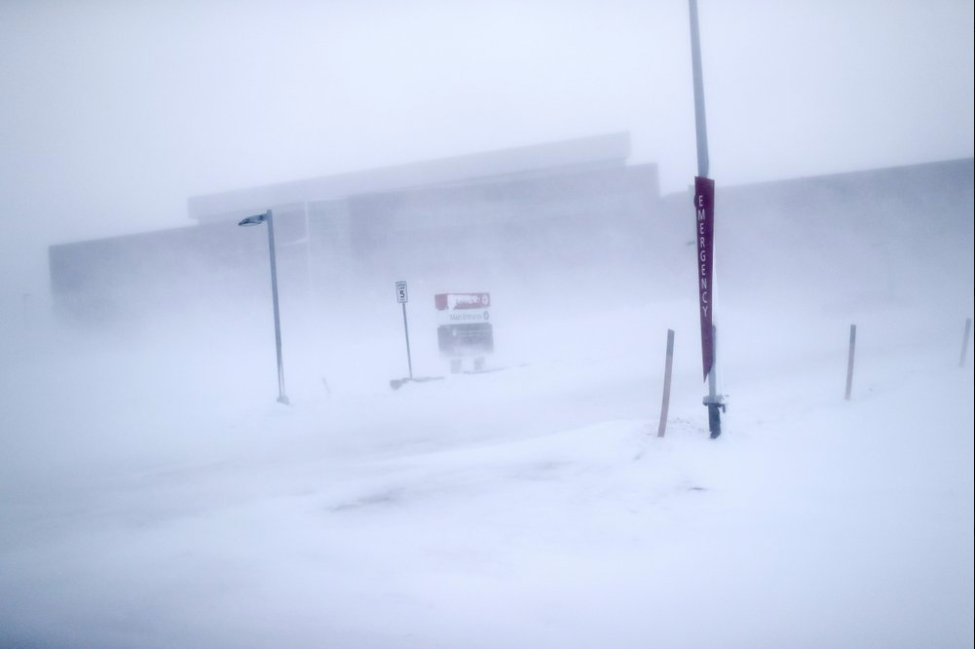 In this Feb. 21, 2019, photo, the entrance to Norton Sound Regional Hospital is seen through a snow storm in Nome, Alaska. The hospital serves Nome and surrounding villages of the Bering Strait region. Image by Wong Maye-E. United States, 2019.