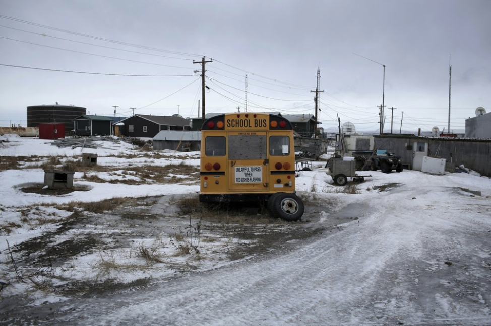 In this Feb. 18, 2019, photo, a yellow school bus is parked outside a residential area in the Native Village of St. Michael, Alaska. According to a list released in 2018 by Jesuits West, seven priests and one lay person were credibly accused of sexually abusing children in this town of 400 people between 1949 and 1986. Image by Wong Maye-E. United States, 2019.