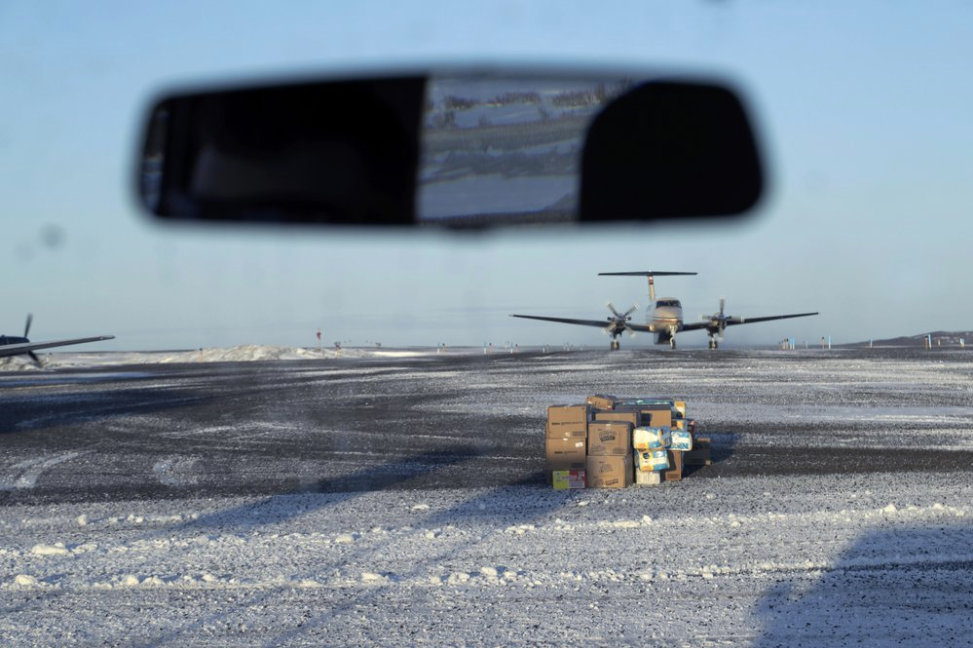 In this Feb. 19, 2019, photo, a pile of deliveries sit on the tarmac of the airport in the Native Village of St. Michael, Alaska, population 400. Transportation from villages to Nome is limited to air travel. Image by Wong Maye-E. United States, 2019.