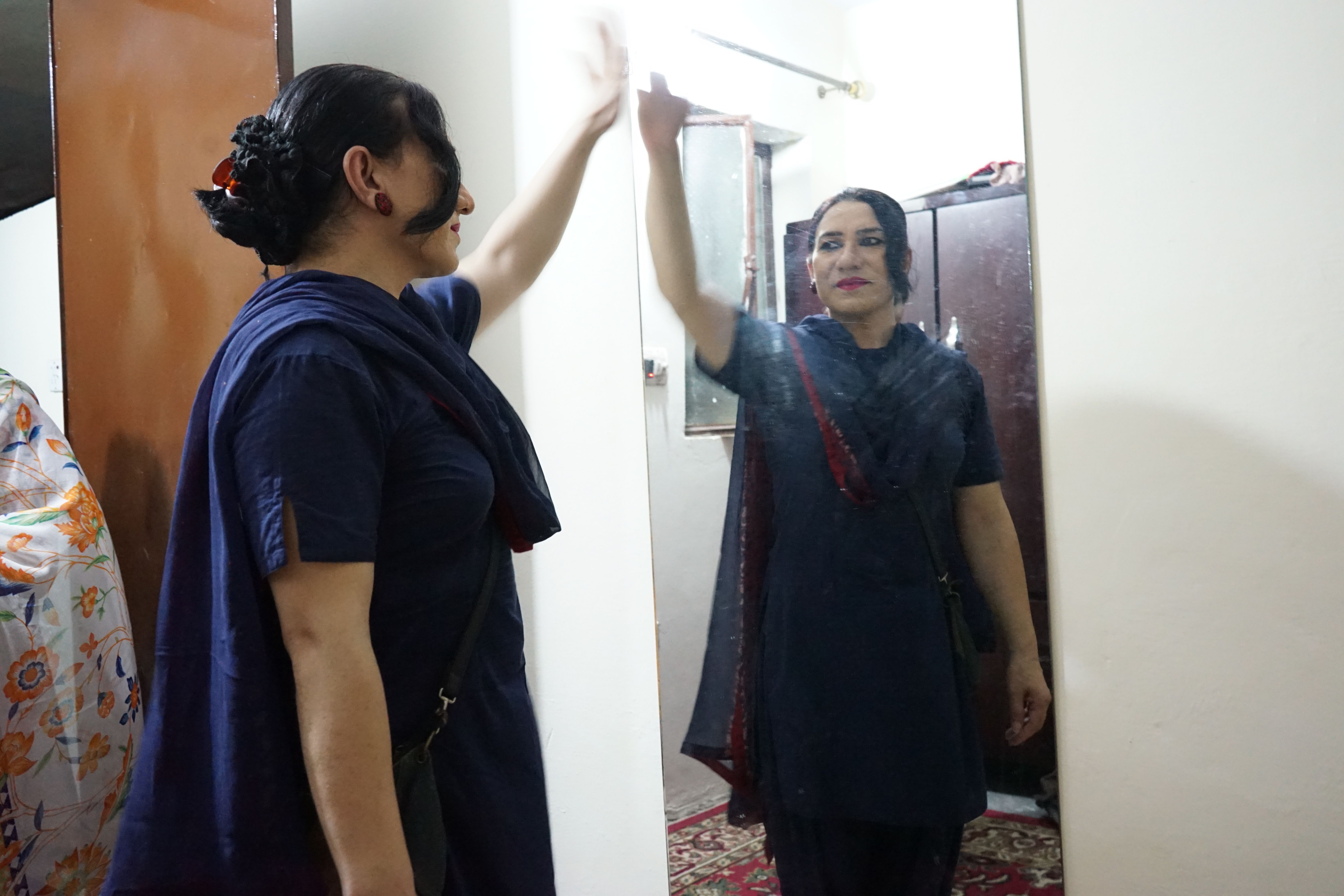 Billi poses in the mirror at Zakiyya's place after opening her fast. She is Zakiyya's beti (or daughter) in the khawaja sira kinship system
