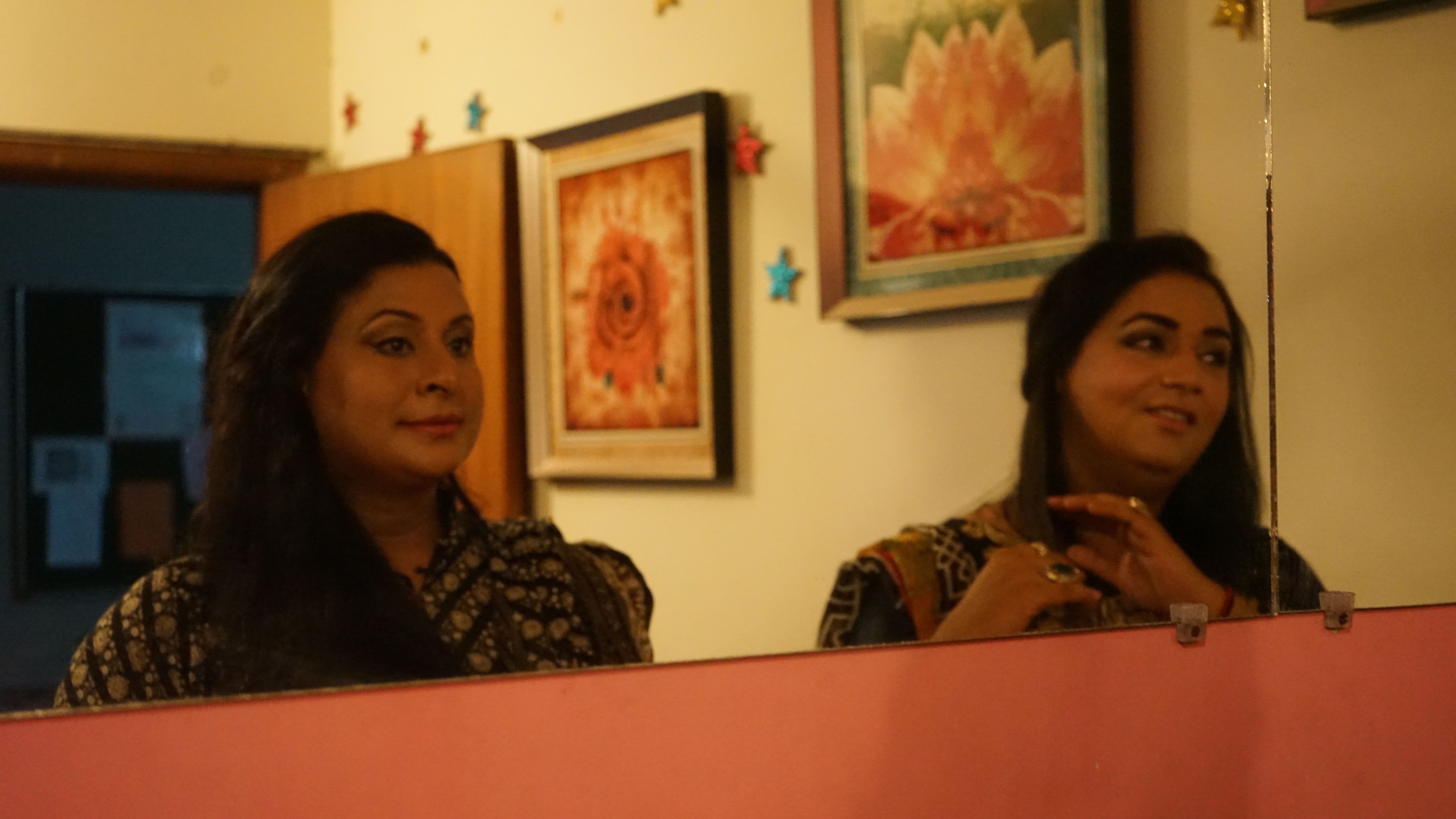 Neeli and Zehrish glance in the mirror after returning from a television appearance