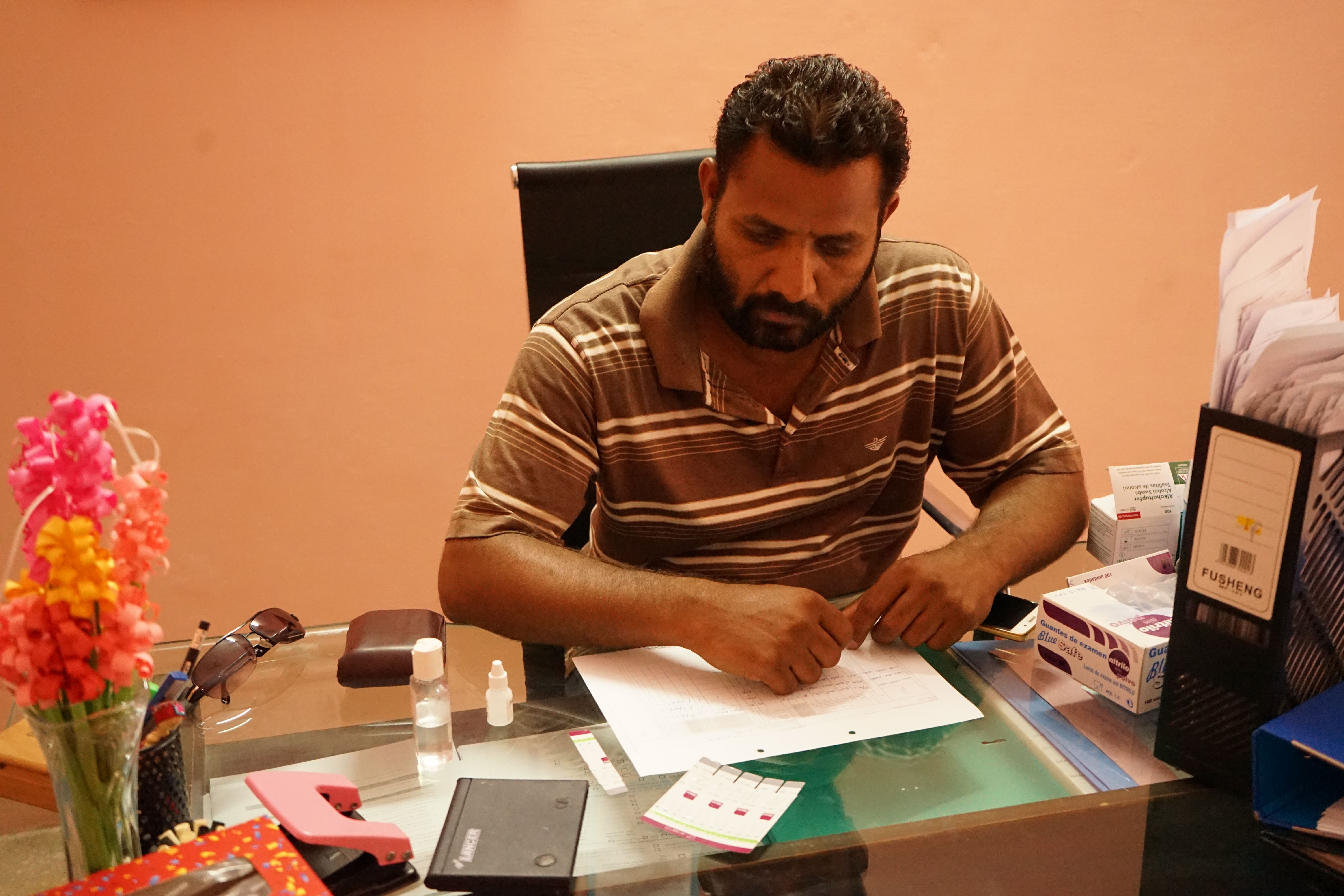 Phlebotomist Shabhaz Roy in his office at Khawaja Sira Society administers free HIV/AIDS testing