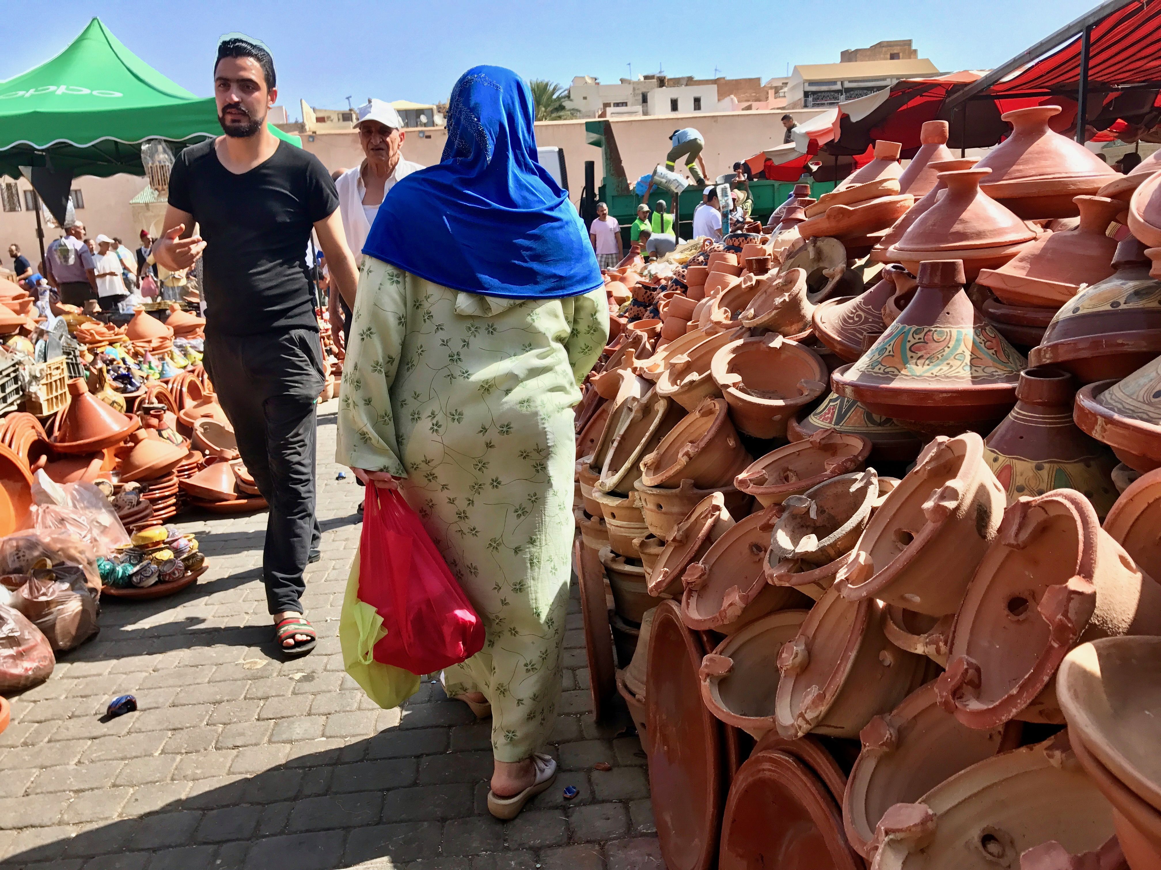 A shopper carries goods in cloth bags after leaving the medina in Meknes, Morocco. The most visible sign of the country’s green policy efforts are on the streets of the old medinas, in the vegetable shops, and in the large supermarkets of the big cities. In 2016, Morocco banned the sale, use, and production of plastic bags. Before the ban, Morocco used 3 billion plastic bags a year, making it the second largest consumer after the US, according to environmental groups. Image by Jackie Spinner. Morocco, 2017.