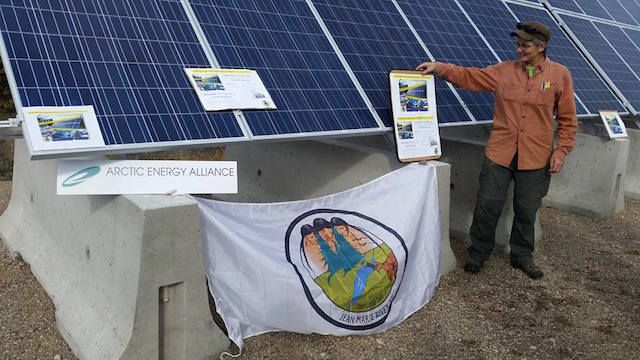 Teresa Chilkowich, of Arctic Energy Alliance, in front of the new solar panel in Jean Marie River. Image by Jean Marie River First Nation. Canada, 2016.
