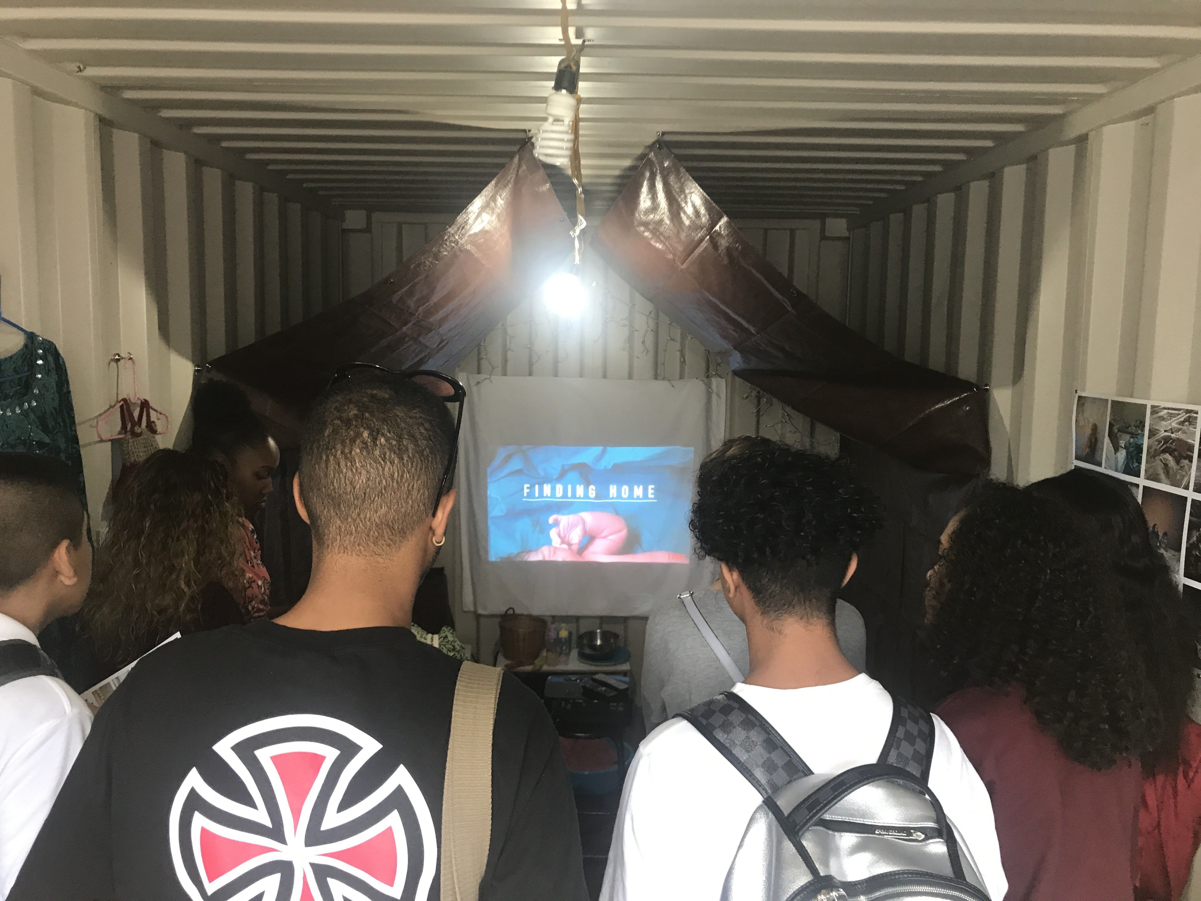 Students watch the trailer for "Finding Home" at Photoville 2017. As part of Photoville's Education Day, Pulitzer Center presented "Finding Home" to students across the four boroughs of New York City. Image by Jordan Roth. United States, 2017. 