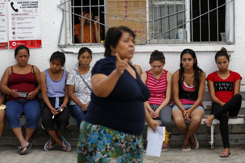 In this July 29, 2019, photo, Marta Alicia Esquivel, a volunteer at El Buen Pastor shelter for migrants, center, scolds a group of migrant mothers about the care of their children and asks for more help with cleaning at the shelter in Cuidad Juarez, Mexico. Image by Gregory Bull. Mexico, 2019.