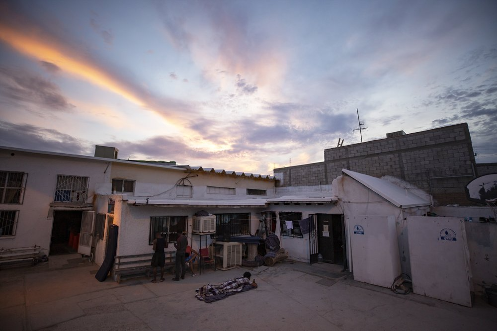 In this July 27, 2019, photo, a migrant wakes up before sunrise at El Buen Pastor shelter for migrants in Cuidad Juarez, Mexico. Image by Gregory Bull. Mexico, 2019.