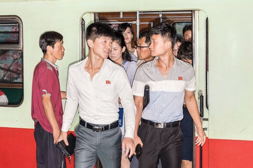 Commuters on the Pyongyang Metro. The capital, marooned by politics, presents a panorama from another time. Image by Max Pinckers/The New Yorker. North Korea, 2017.