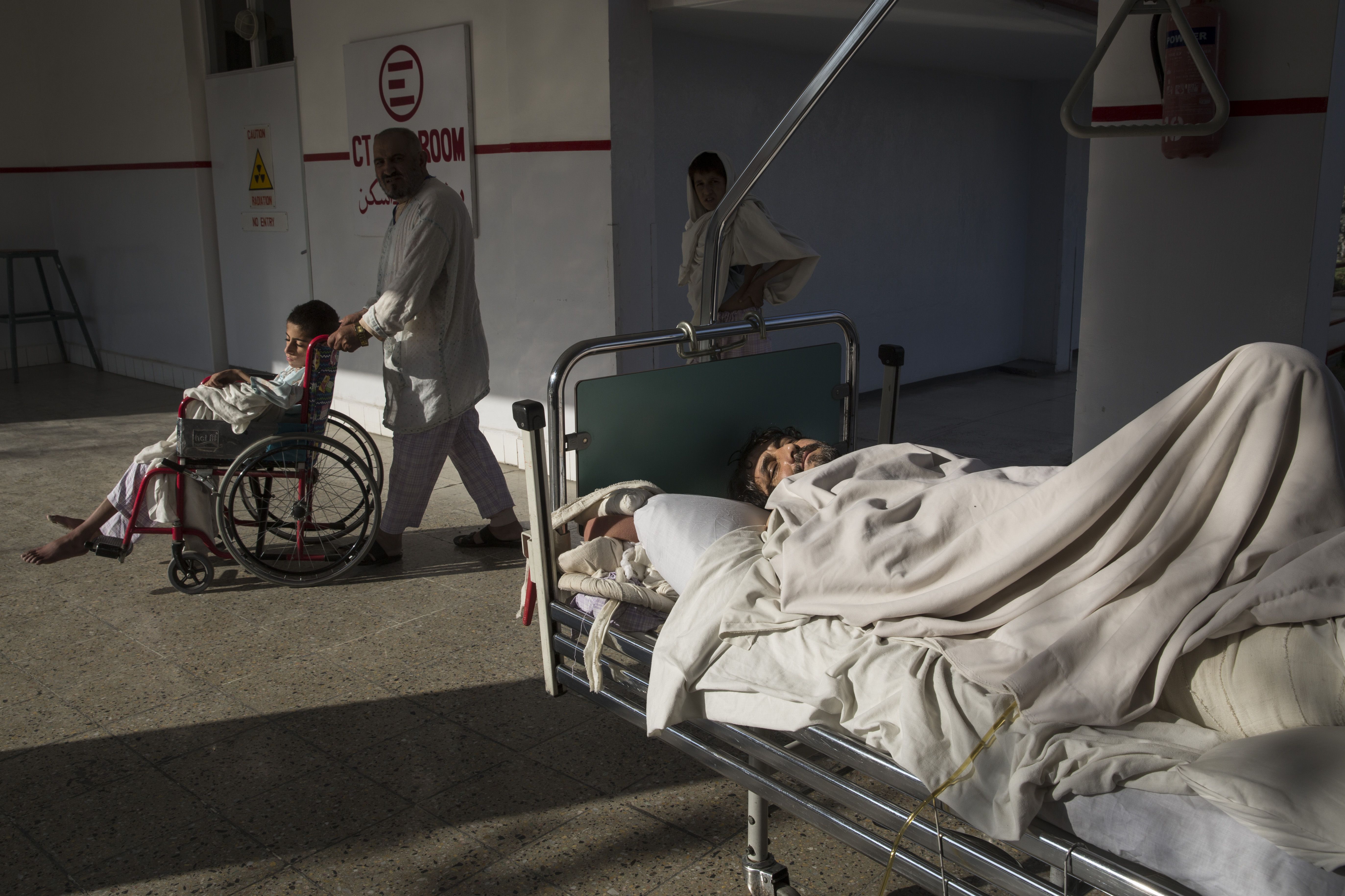 Patients enjoy a sunny day at the emergency hospital for the war wounded. Image by Paula Bronstein. Afghanistan, 2015. 