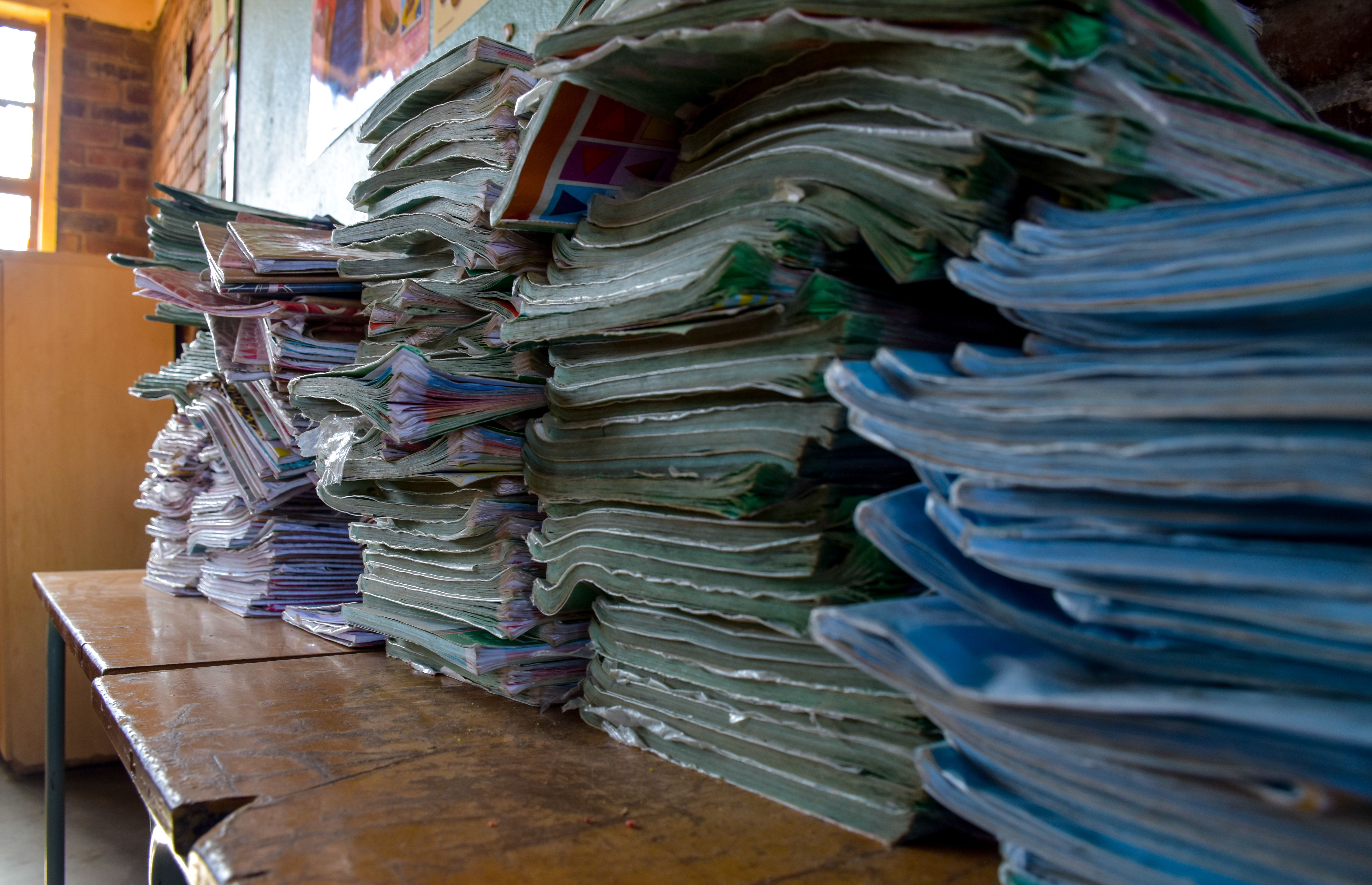 A pile of old textbooks at Utjane Primary School in Limpopo. Many rural schools lack libraries as well as other components of a "basic education." Image by Adam Yates. South Africa, 2018.