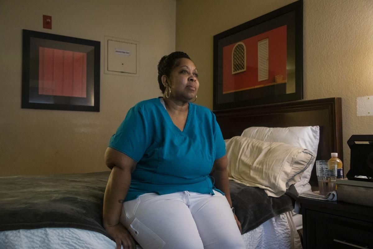 Catrice Otengo sits for a portrait on July 31 in the Greensboro hotel room she is renting following an eviction during the coronavirus pandemic. Image by Casey Toth / The News & Observer. United States, 2020.