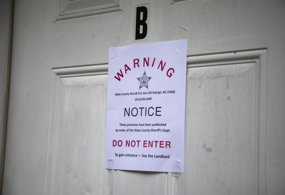 A padlock notice is taped to the door of an apartment, whose tenant was unavailable for comment Aug. 19 in Raleigh. Image by Casey Toth / The News & Observer. United States, 2020.