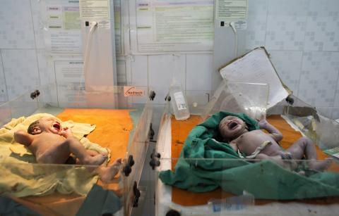 Two babies, shortly after being born by caesarean delivery, at Medavakkam Primary Health Centre, a government-run public hospital outside Chennai. Image by Sarah Weiser. India, 2014.