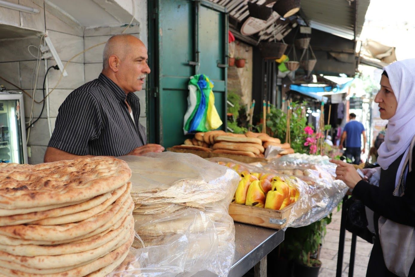 Many Jerusalemites come to the market to buy taboun bread as well as freshly baked items like ka’ak, mana’eesh and pita. Image by Carly Graf. Israel, 2019.