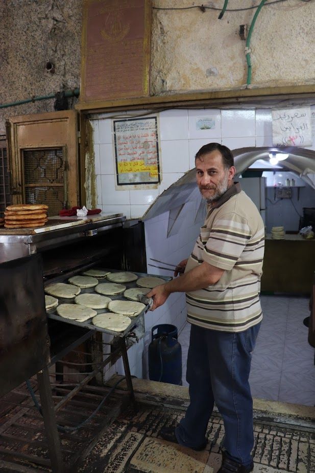 Different cities throughout the West Bank have their own take on street food. In Nablus, it often means pita bread rounds stuffed with ground lamb or beef and baked in an oven before serving. Image by Carly Graf. Palestine, 2019. 