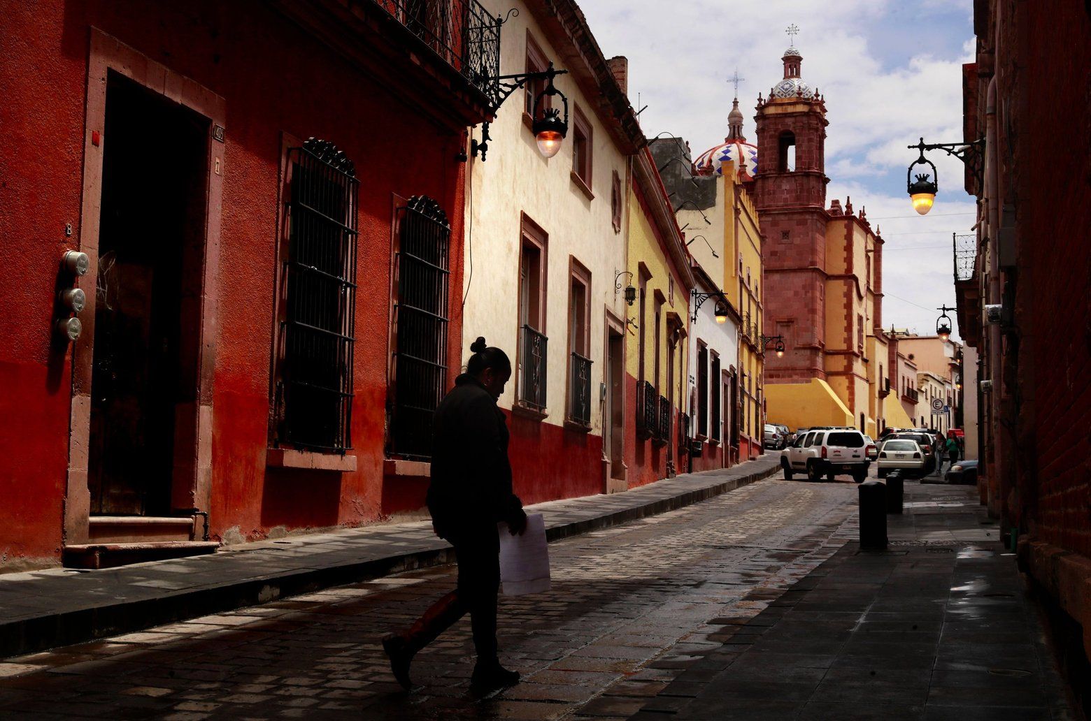 A pedestrian walks through Zacatecas. Image by Erika Schultz. Mexico, 2019. 