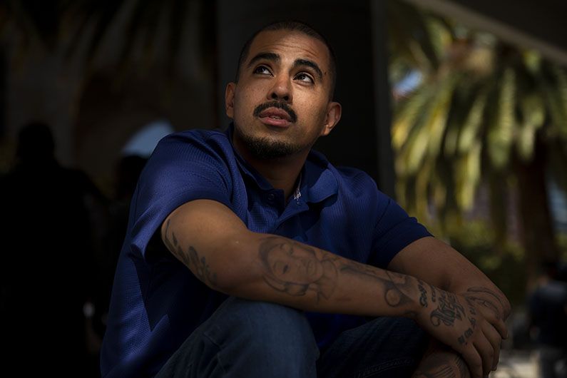 Rogelio Hernandez, taking a break from his call-center job, is a former welder from California. He said it was hard to find work due to his tattoos; Mexicans often associate tattoos with organized crime. Image by Erika Schultz. Mexico, 2019.