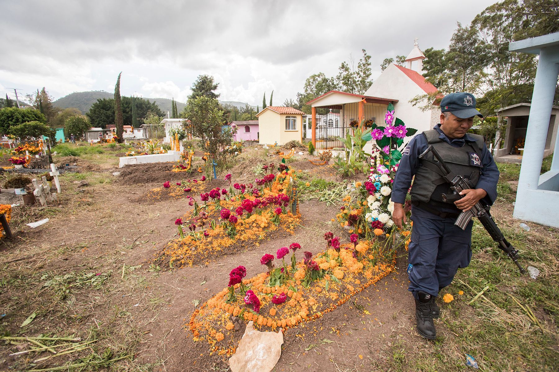 Chilapa has one of the highest homicide rates in the country. The police patrol the municipal cemetery on Day of the Dead. Image by Omar Ornelas/The Desert Sun. Mexico, 2019.