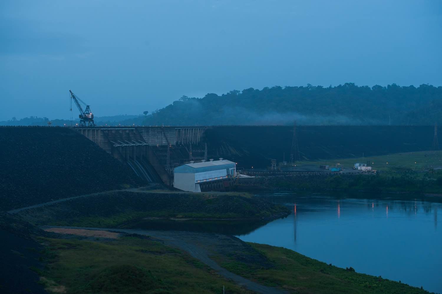 Alcoa's plans to leave the country have left the ownership of the Afobaka Dam — here, at dawn — up for debate. Image by Stephanie Strasburg. Suriname, 2017.