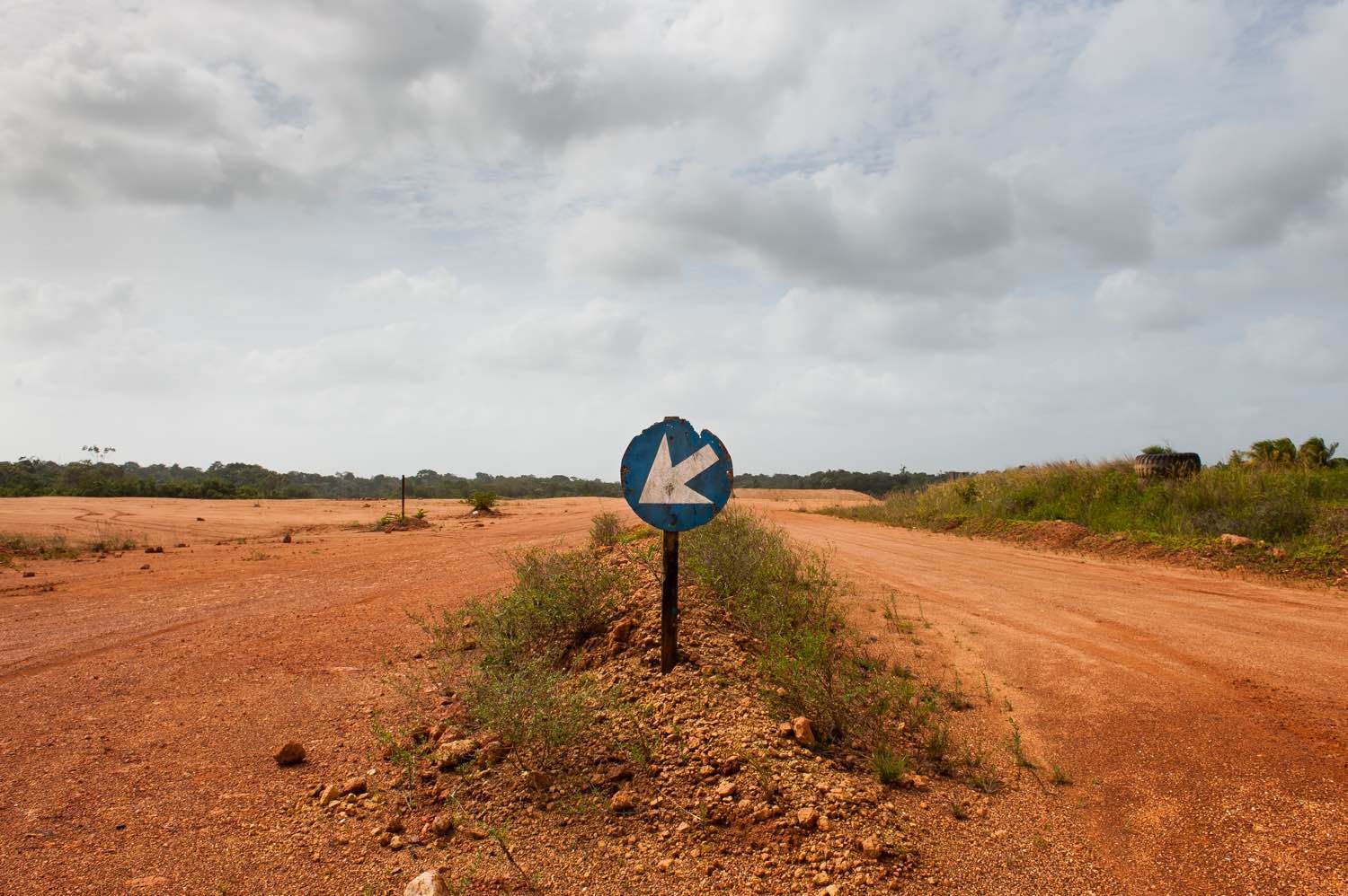 Red bauxite roads run for miles around the shuttered mining and mill operations that once made Suralco one of Suriname's largest employers. The company, a subsidiary of Alcoa, has promised to remediate the land. Image by Stephanie Strasburg. Suriname, 2017.
