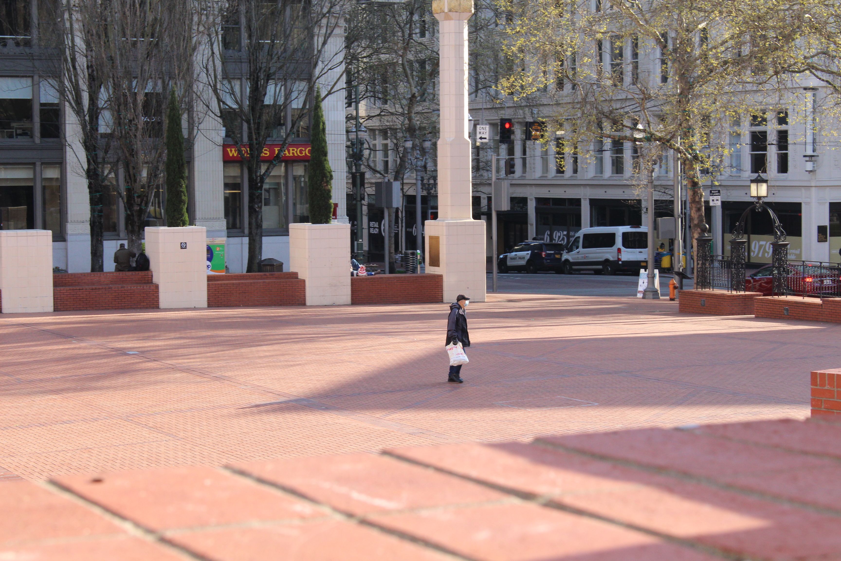 April 7, 2020 – A lone man walks across Pioneer Courthouse Square in downtown Portland. Image by Sarah Fahmy. United States, 2020.