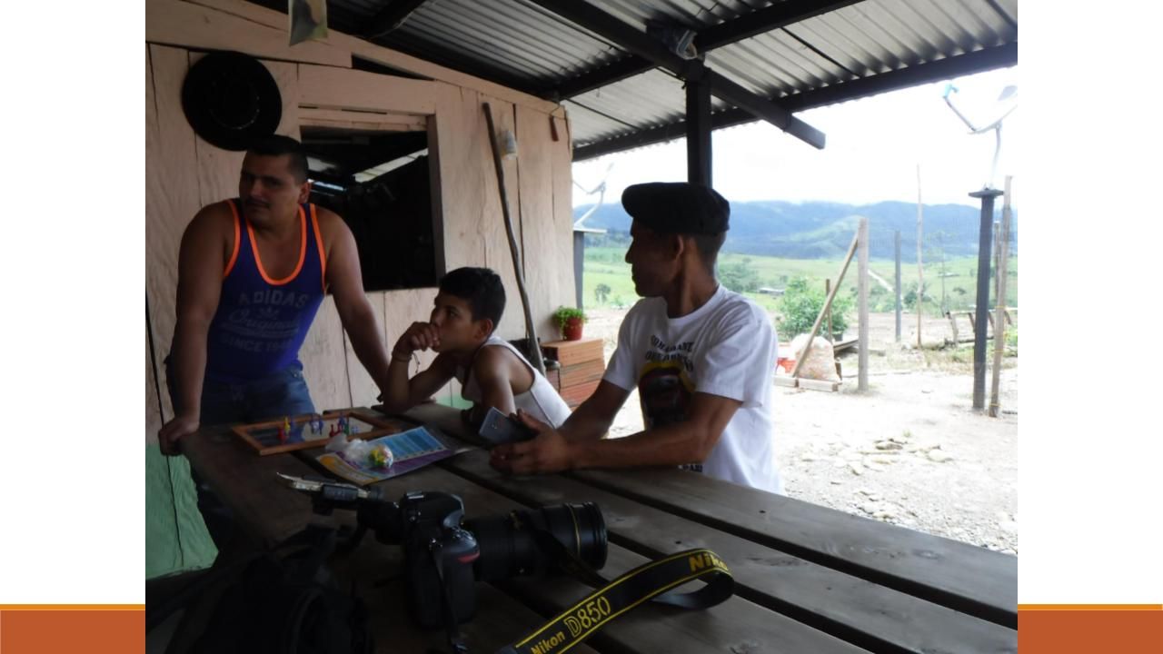 Former FARC militants Wilmer Pérez, left, and Eder Cristian, right, play checkers at the Mariana Paez transition zone near Mesetas, Colombia, in 2018. Pérez has been trying to start a yogurt business but hasn’t been able to expand due to lack of access to capital. Both expressed disappointment with the land reform process promised in the 2016 peace accord. Image by Julia Friedmann. Colombia, 2018.