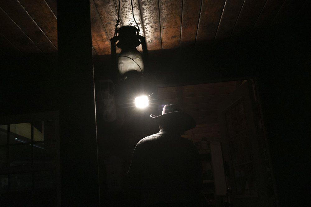 A spotlight illuminates Donald Dutiel's cowboy hat at the entrance to one of his homes at a ranch in New Lexington, Ohio, on Tuesday, July 28, 2020. Image by Wong Maye-E/AP Photo. United States, 2020.