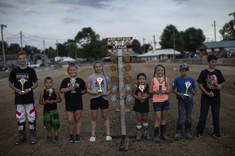 Young motorcycle and APV racers pose with their trophies at the Perry State Fair in New Lexington, Ohio, Friday, July 24, 2020. Image by Maye-E Wong/AP Photo. United States, 2020.