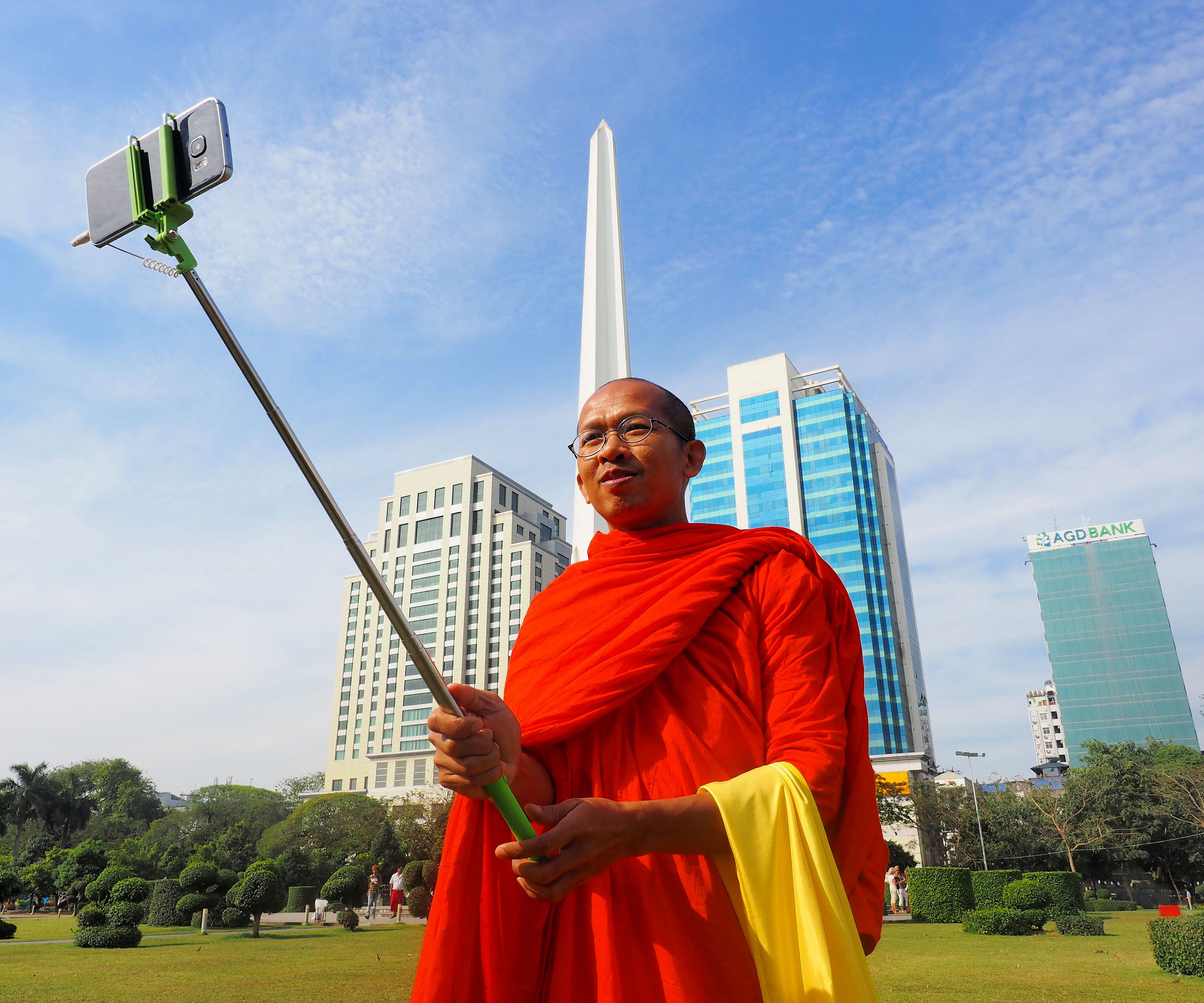 A monk takes a selfie in Yangon. Image by Doug Bock Clark. Myanmar, 2017.