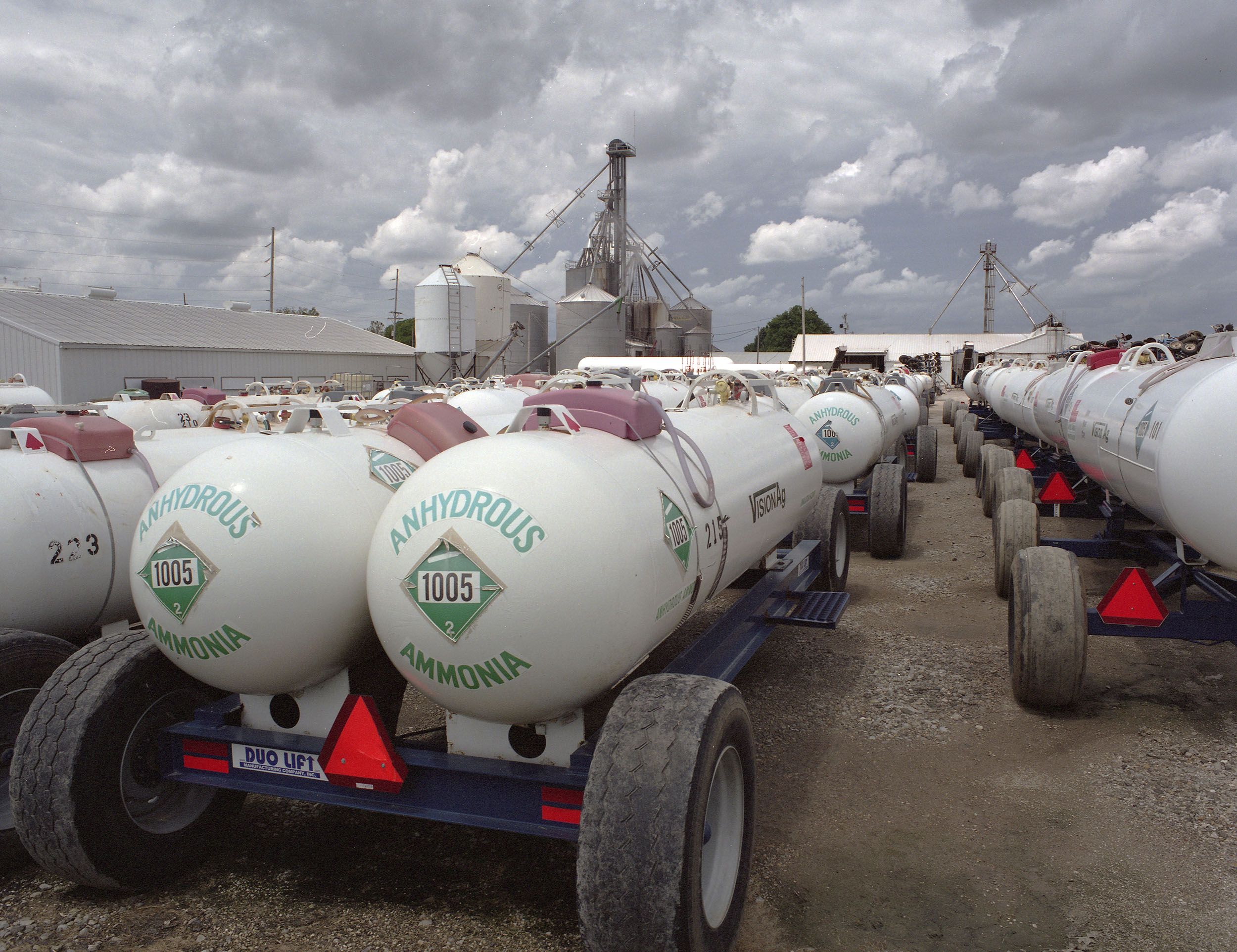 Keota, Iowa - Fertilizer trucks parked at Vision Agriculture. Alongside the Hypoxia Task Force’s promise to shrink the dead zone by 20 percent, Iowa’s Nutrient Reduction Strategy have also promised to make a 45 percent decrease in fertilizer runoff. Image by Spike Johnson. United States, 2019.