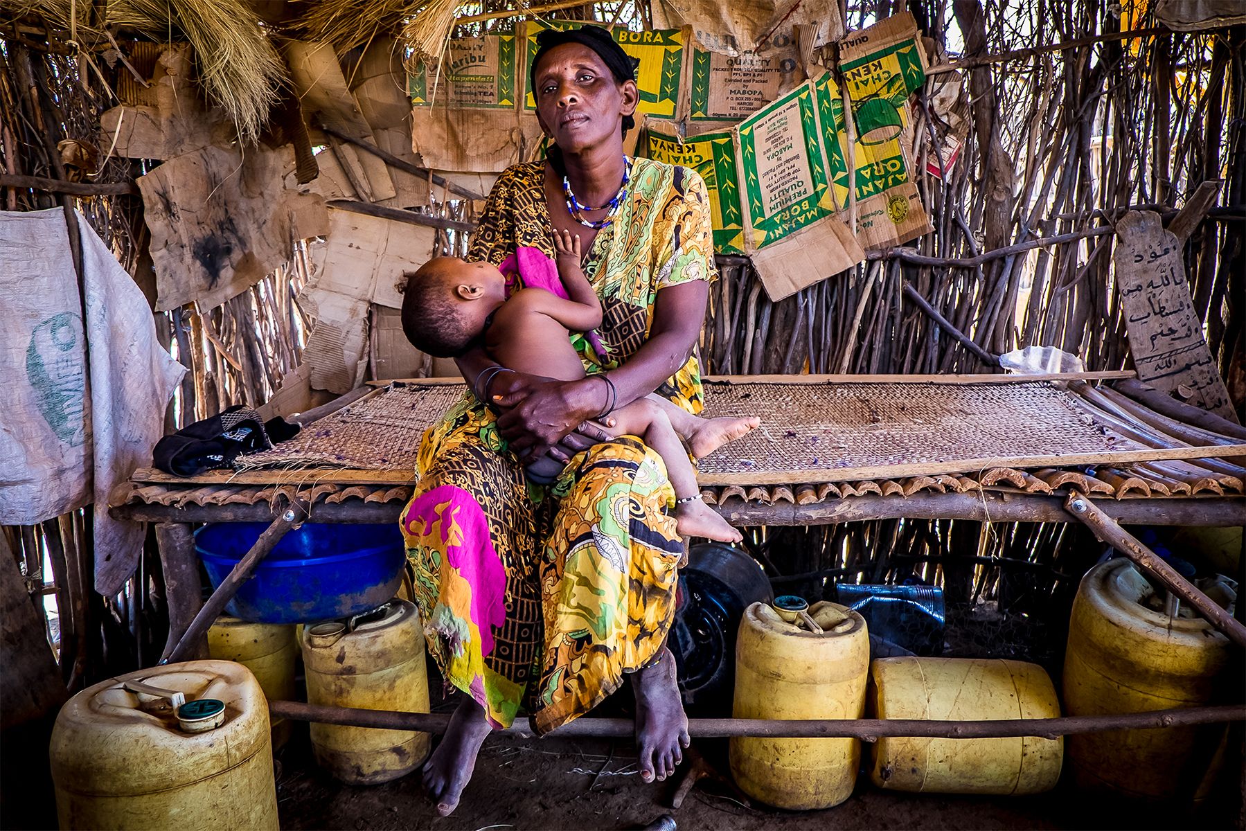 Bisharu al-Hussein, 42, sits with her young son, her tenth child, in their home in Gafarsa, a goat-herding community in Kenya. Bisharu lost her ninth child in pregnancy because she was unable to access appropriate medical care. In Kenya, maternal mortality has only been reduced by one-half of one percent for each of the last twenty years. Kenya’s government is partnering with civil society to provide free maternal health services to mothers to improve their lives and childbirth safety, but many challenges a