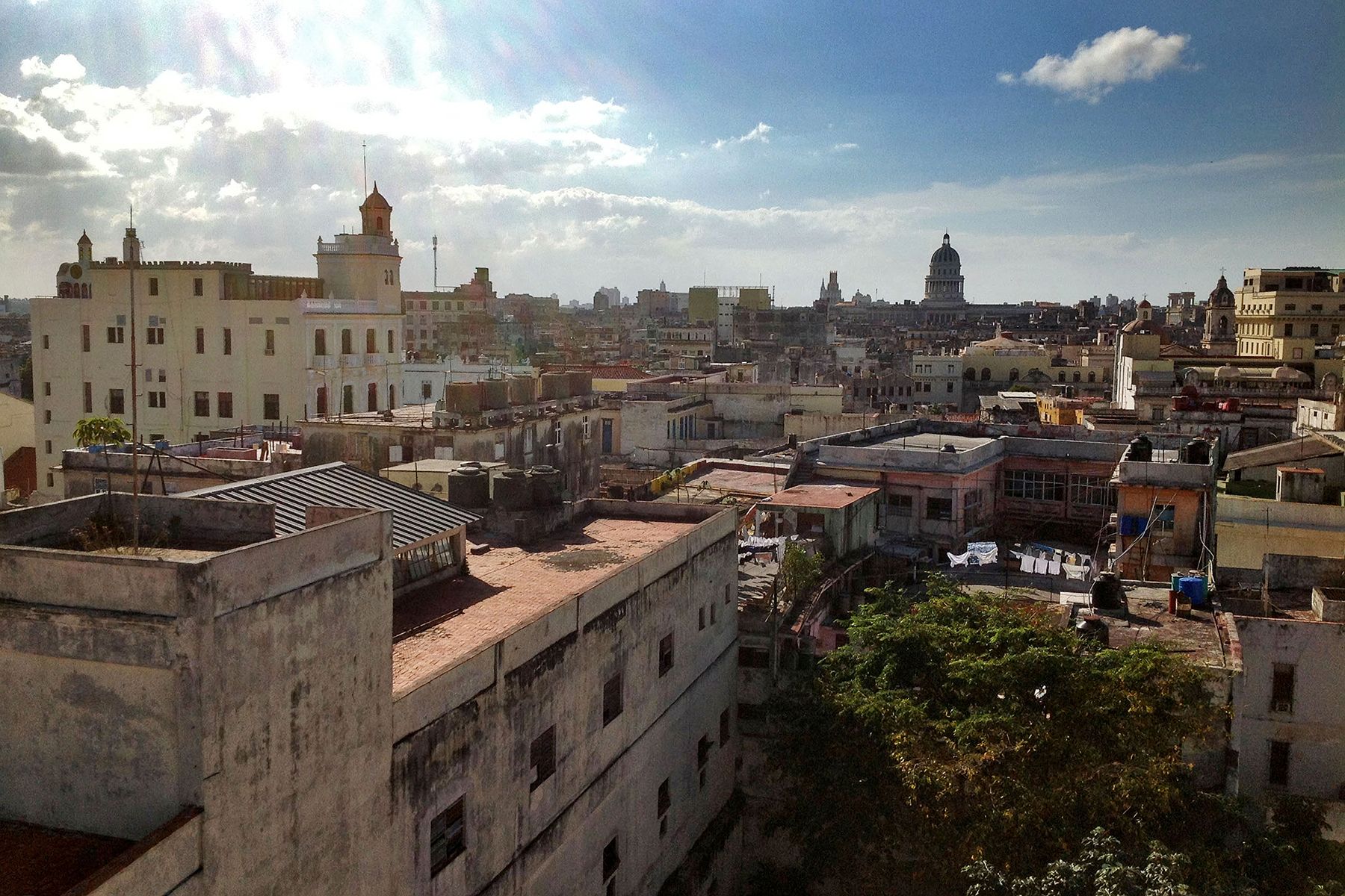 The view from the top of the bell tower in the historic Saint Francis of Assisi Church shows the disparity between various parts of Havana. The capitol building in the background stands tall and bright, but many apartment buildings are weathered and in need of repair. Image by Rachel Southmayd. Cuba, 2013.
