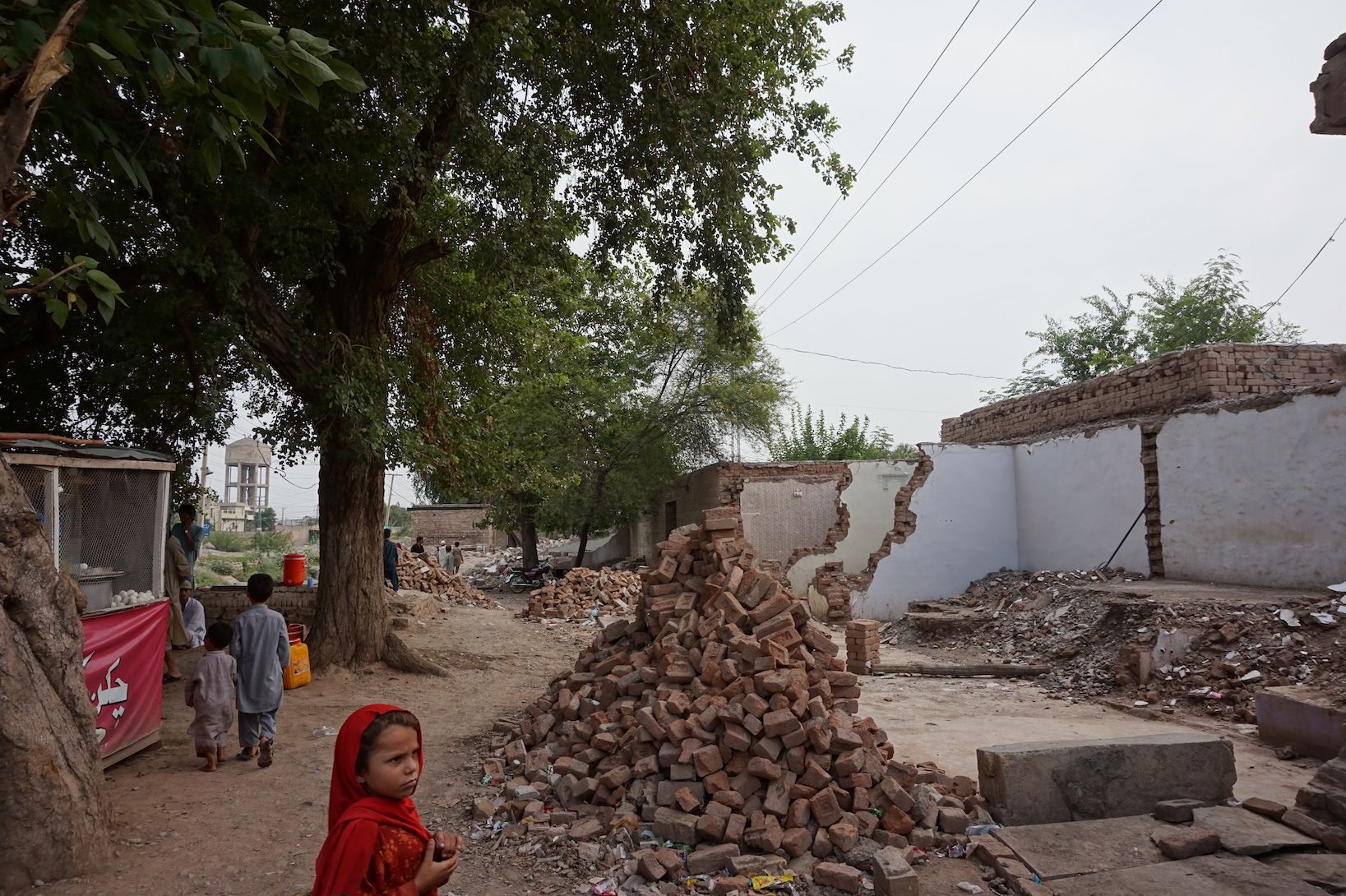 A child watches as a row of shops is demolished by authorities for collective punishment in Khyber Agency, in the Federally Administered Tribal Areas. Image by Umar Farooq. Pakistan, 2017.