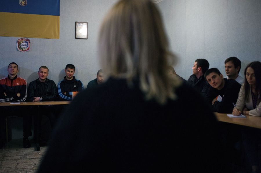 Sveta Moroz from NGO Svitanok Club educates Borispol's patrol officers on modern approaches to dealing with drug users. Image by Misha Friedman. Ukraine, 2016.