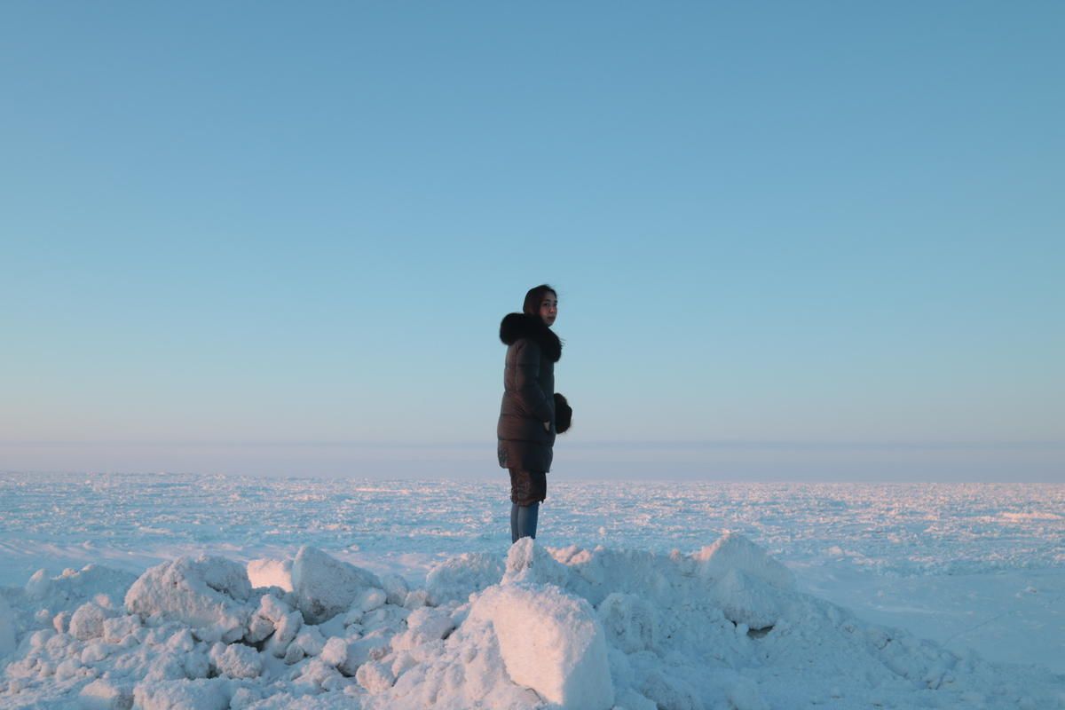 Coffee & Quaq podcast host Alice Qannik Glenn overlooks the frozen Arctic Ocean in February. Image by Jenna Kunze. United States, 2020.
