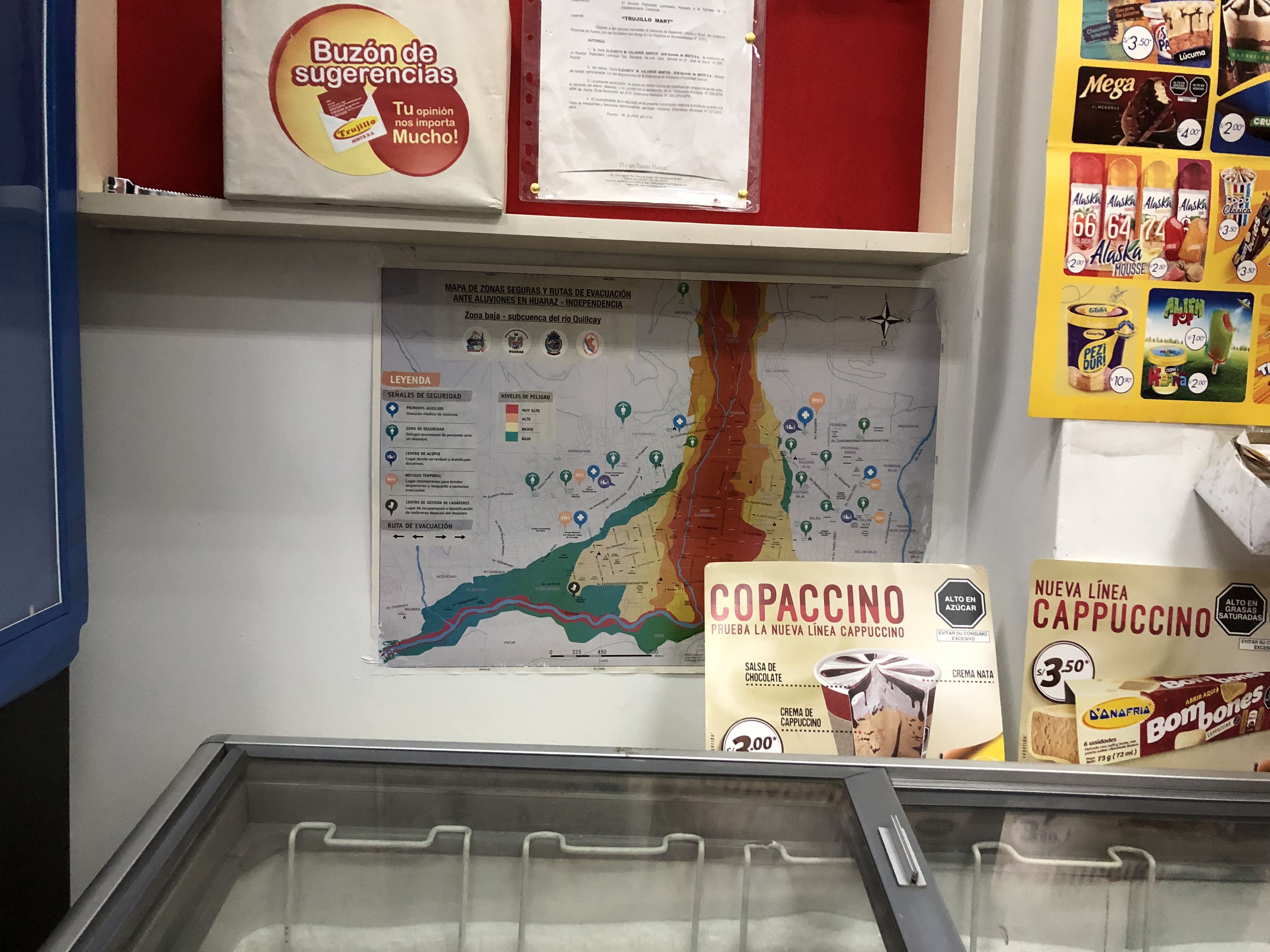 A printed evacuation plan posted behind a freezer in a Huaraz grocery store. Image by Audrey Fromson. Peru, 2019.