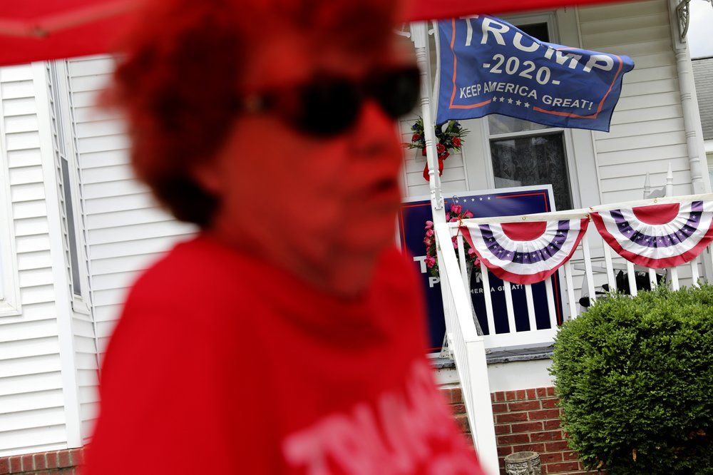 Doris Miller 86, tends to her makeshift store selling Trump souvenirs in front of her home, Sunday, Aug. 2, 2020, in Vienna, Ill. This is a deeply conservative part of the nation. 77 percent of the county voted for President Donald Trump in the 2016 elections; just 19 percent went for Hillary Clinton. Image by Wong Maye-E/AP Photo. United States, 2020.
