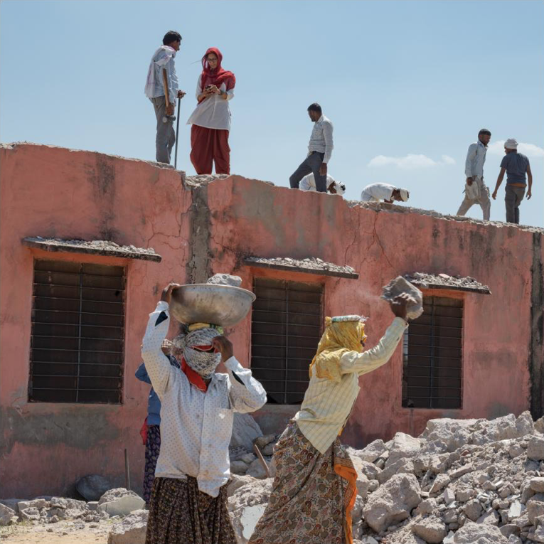 Village Head, India: This north Indian village’s sarpanch—elected leader, local-national government liaison, and chief dispute-resolver—is 43-year-old Chhavi Rajawat, here standing atop a school under renovation. Rajawat, who earned a business management degree, pushes girls in this deeply traditional region to pursue an education, and their families to support it. “I am a daughter of this village,” she says. Image by Lynn Johnson. India, 2019.