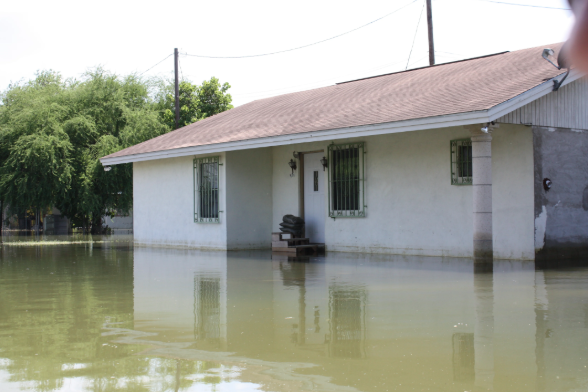 Rains from Hurricane Alex flooded streets in Roma, Texas, with more than 3 feet of water in July 2010. Roma is one of the communities along the Rio Grande where a border wall is to be built. Image by Daniel Llargues / FEMA. United States, 2010.
