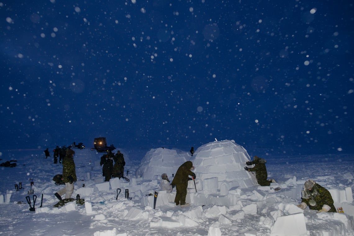 Canadian soldiers on the Arctic operations advisers course build igloos under the supervision of Inuit instructors at the Crystal City training facility near Resolute Bay, Nunavut. Image by Louie Palu / Zuma Press. Canada, undated. 