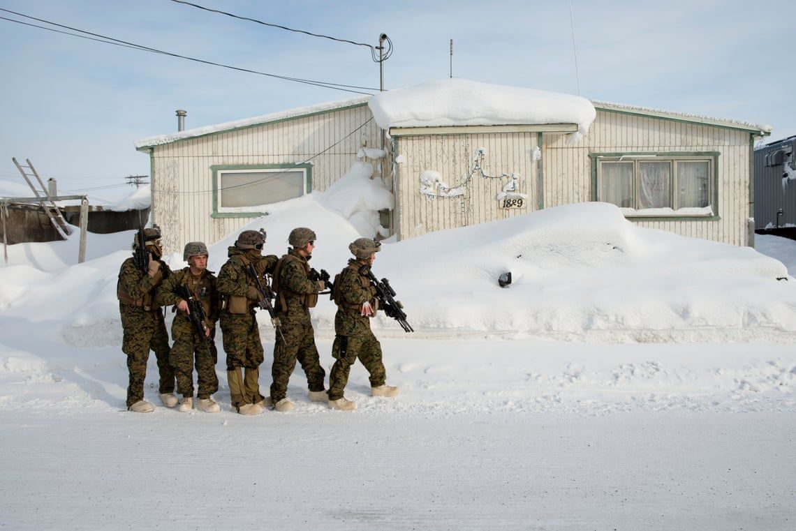 Marines practice room clearing in buildings outside a U.S. national guard barracks in Utqiagvik, formerly known as Barrow, in Alaska. These marines were training for an upcoming deployment to Norway. Image by Louie Palu / Zuma Press. United States, undated.